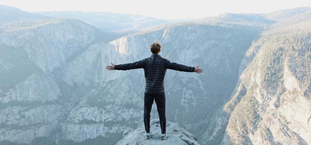 Man standing on top of a mountain